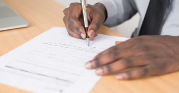man completing a job application form