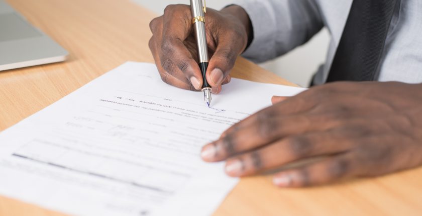 man completing a job application form