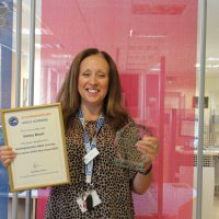 EmmaBrunt3 woman holding certificate and award