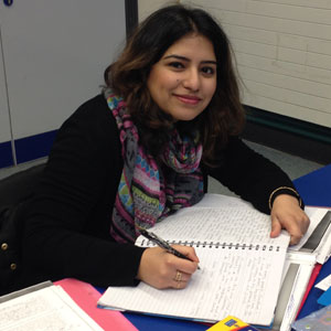 Woman sitting writing in a note pad