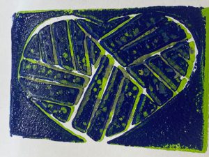 lino print of a heart in blue and green