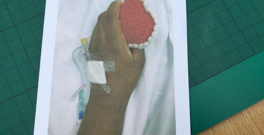 Hospital patient holding a knitted heart