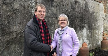 Man shaking hands with woman