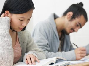 Two adult learners reading