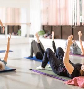 Group of women and tutor in pilates class