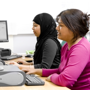 Two women working on computers