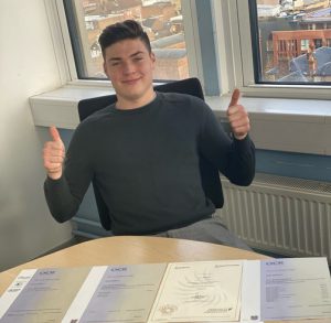 Young man with thumbs up and apprenticeship certificates