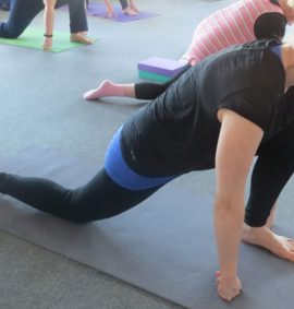 Woman practising yoga on yoga mat