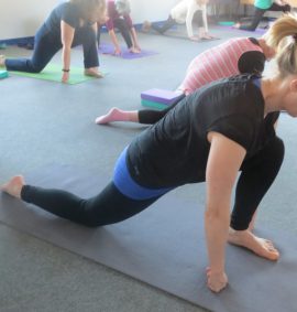 Woman practising yoga on yoga mat