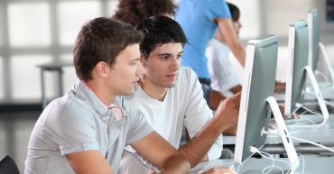 Two men looking at computer screen