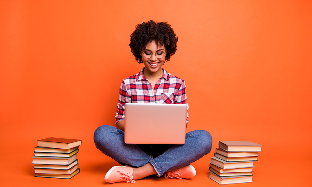woman with laptop and books